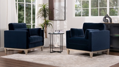 three navy chairs in a living room setting with table