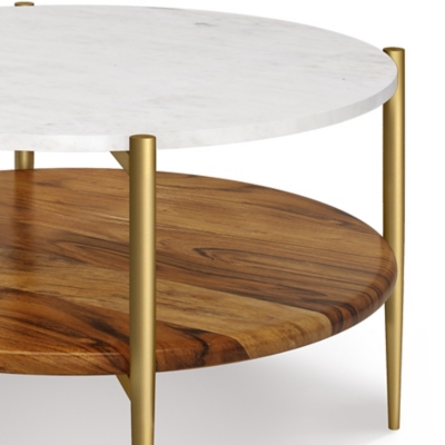 Close-up of round marble upper surface and gold legs of a two-tier side table
