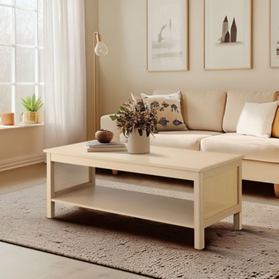 Light wood coffee table in living room with sofa, decorative items, and neutral decor