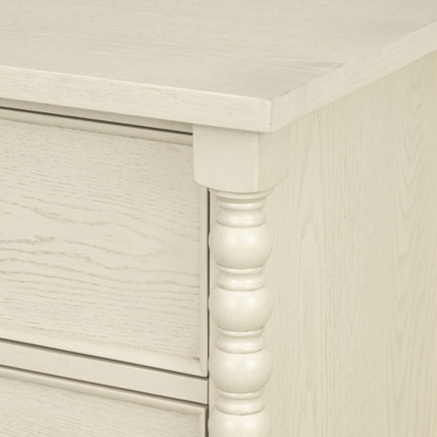 Close-up of the dresser corner with turned leg detail in cream finish