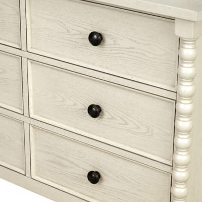 Dresser front with drawers and dark knobs