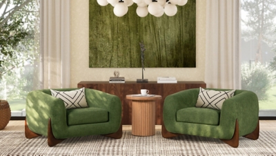 green chairs around a round ribbed wooden side table in living room