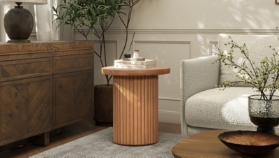 round ribbed wooden side table in living room