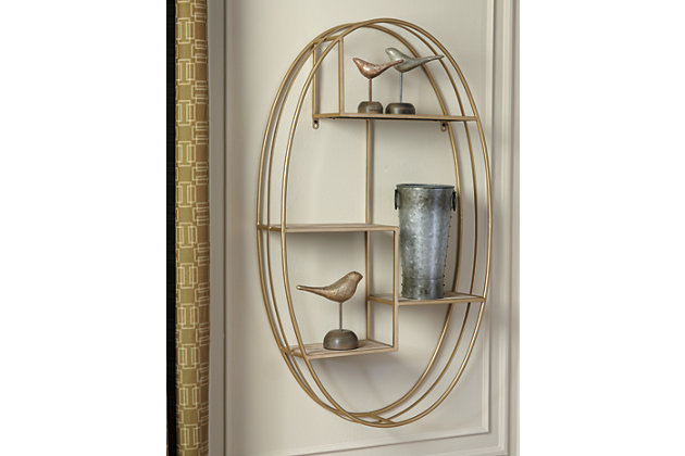 The Elettra wall shelf is an unexpected and striking combination of goldtone metal and natural wood. Ellipse design has an earthy luxe feel. Hang it up and adorn the four open shelves with trendsetting accessories.Made of natural wood and goldtone metal | 4 open shelves | Keyhole bracket hanger
