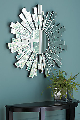 Need a burst of light for a dark interior? Radiant light is delivered from the sunburst design of the Braylon accent mirror. Framed in a mosaic spray of cut glass tiles, the circular beveled mirror will beautifully brighten up any wall space.Cut glass frame | Circular beveled mirror | Keyhole bracket hanger | Clean with a soft, dry cloth