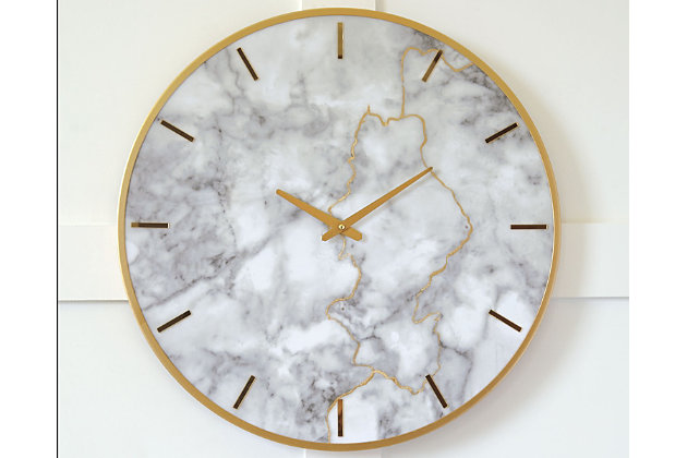 Time is captured in irresistible beauty with the Jazmin wall clock. Gorgeous striations in the faux marble face are highlighted with goldtone finished metal. This contemporary mix of materials hangs artfully in your home.Made of metal with faux marble face | Keyhole bracket hanger | Operates with 1 AA battery (not included) | Clean with a soft, dry cloth