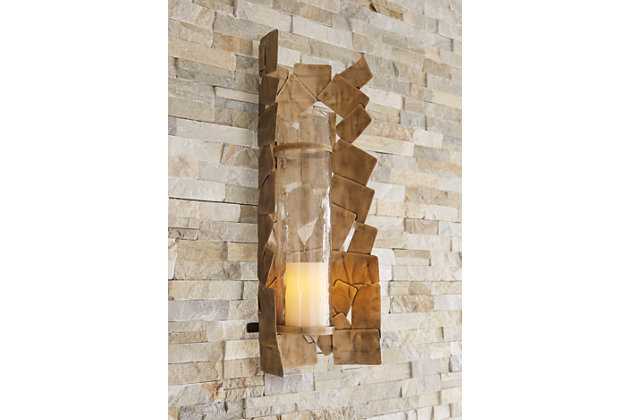 Light up your space with contemporary style with the Jailene wall sconce. The antiqued goldtone finish of the stacked shapes adds a classic element to this very modern piece. Add in your own candle and enjoy your very chic space.Made of metal and glass | Antiqued goldtone finish | Keyhole bracket | Ready for hanging