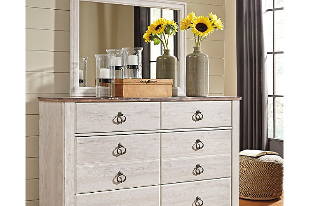 The Willowton dresser and mirror set is the ultimate statement piece for a coastal cottage or shabby chic inspired retreat. Whitewashed finish on the drawers and sides is wonderfully easy on the eyes. Paired with the unique faux plank top, it’s a driftwoody look that has our minds drifting away to beachy-keen escapes.Includes dresser and mirror | Made of engineered wood (MDF/particleboard) and decorative laminate | Whitewash replicated worn through paint with authentic touch | Replicated wood grained block pattern with authentic touch | Antiqued brass-tone knocker hardware | 6 smooth-gliding drawers | Mirror attaches to back of dresser | Safety is a top priority, clothing storage units are designed to meet the most current standard for stability, ASTM F 2057 (ASTM International) | Drawers extend out to accommodate maximum access to drawer interior while maintaining safety | Assembly required | Estimated Assembly Time: 5 Minutes