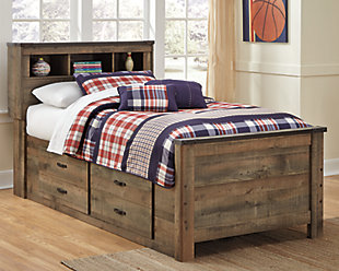 Whether she loves horses or he's a cowboy at heart, Trinell twin bookcase bed with under bed storage matches their authenticity. Rustic finish, plank-style details and nailhead trim pay homage to reclaimed barn wood, making for a chic look loaded with charm. Mattress available, sold separately.Includes bookcase headboard, footboard, under bed storage with side rail and slats | Made of engineered wood and decorative laminate | Warm rustic plank finish over replicated oak grain and authentic touch | 2 large storage drawers | Nailhead accents | Bed does not required a foundation/box spring | Mattress available, sold separately | Assembly required | Estimated Assembly Time: 30 Minutes