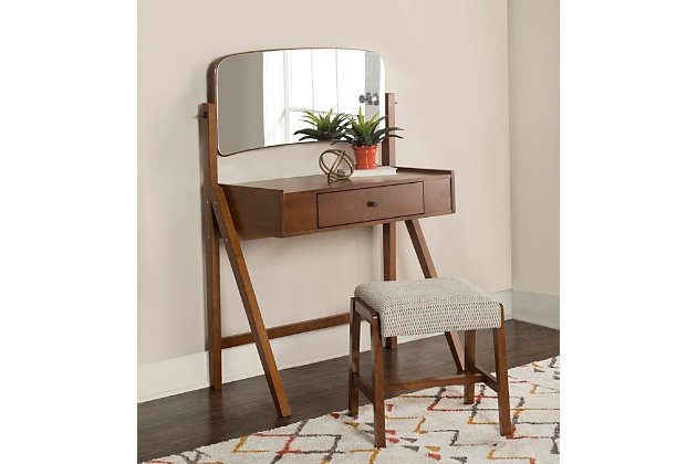 What's amazing about mid-century style is that it doesn't go out of style. The design of the Bristian vanity set is perfect for bringing simplicity, eye-catching beauty and versatility to your space. You’ll love the spacious tabletop, which gives you room for keeping perfume bottles, trinkets and more within reach. A handy drawer provides enough space to keep small items organized. Best of all, the large adjustable mirror can easily be tilted to suit your height. The matching stool has an inviting cushioned top that's plush and upholstered in a neutral patterned fabric. This set also easily complements traditional decor.Made of rubberwood, wood, engineered wood, birch veneer, foam and fabric | Walnut-colored finish | Adjustable mirror | Storage drawer | Includes stool with plush cushioned top upholstered in a neutral patterned fabric | Assembly required