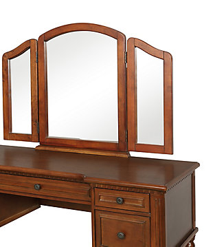 With all the allure of a treasured heirloom—at a fraction of the price—this beguiling 3-piece vanity set will fit right in. A softly padded seat welcomes, while the warm cherry-tone finish and tri-fold mirror are clear reflections of your good taste. And when you’ve perfected your look, five drawers keep the top uncluttered and essentials close at hand.Includes vanity, mirror and stool | Made of rubberwood and engineered wood | Cherry-tone finish | Stool with foam cushioned seat with cotton/polyester upholstery and turned spindle legs | Hinged tri-fold mirror | 5 drawers with raised frame fronts and antiqued brass-tone pulls | Assembly required | Ships in 2 boxes