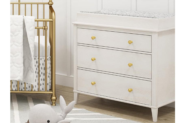 Prepare for the changes ahead with Little Seeds Monarch Hill Poppy 3-drawer changing table. Remove the changing table top to convert it to a dresser, and you can also customize the look to suit your taste—or your little one’s—with one of the two included sets of pulls. Sporting an off-white finish and an updated design, this versatile piece provides plenty of storage to keep your child’s room neat and organized. This changing table makes a lasting impression at every age and every stage.Includes 3-drawer dresser and changing table top | Made of engineered wood/laminated particle board | Non-toxic, off-white woodgrain finish | 3 smooth-gliding drawers with metal slides | Changing table topper fits most standard sized changing pads (sold separately) | 2 sets of metal pulls (goldtone and silvertone) for a customized look | Anti-tip kit included for extra protection | Assembly required | Ships in 2 boxes