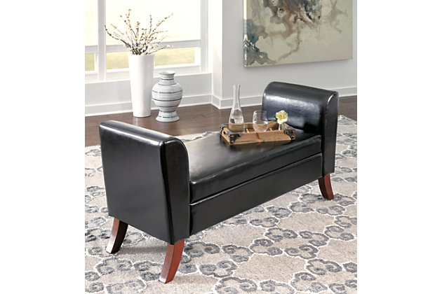 There’s more to this upholstered storage bench than what meets the eye. Supple faux leather upholstery provides a comfy sitting area. Lift up the seat cushion to reveal lots of storage underneath. Coupled with curved legs and flared ends, this bench is full of form and function.Made of wood | Faux leather upholstery | Seat with storage | Assembly required | Excluded from promotional discounts and coupons | Small Space Solution | Includes tipover restraint device | Estimated Assembly Time: 30 Minutes