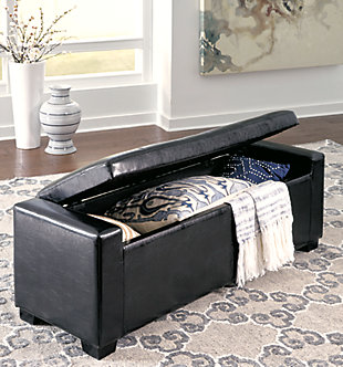 What a handsomely tailored upholstered storage bench. Black faux leather upholstery is elevated with button tufting. Lift the cushion to reveal ample storage for your pillows, throws and more.Made of wood | Faux leather upholstery | Seat with storage | Assembly required | Small Space Solution | Includes tipover restraint device | Estimated Assembly Time: 15 Minutes