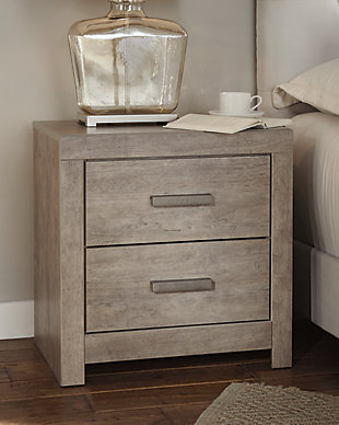 The Culverbach nightstand’s weathered driftwood finish evokes such an ethereal vibe—exactly what you need for your serene master suite. Clean lines and simple yet substantial hardware make for a timeless look you’ll love living with for years to come. Two spacious drawers offer ample storage for all the bedside essentials, while its USB ports make charging wireless devices a breeze.Made of engineered wood and decorative laminate | Warm vintage gray with subtle pearl effect over replicated cherry grain | Pewter-tone hardware | 2 smooth-gliding drawers with replicated linen lining | 2 USB charging ports | Power cord included; UL Listed | Assembly required