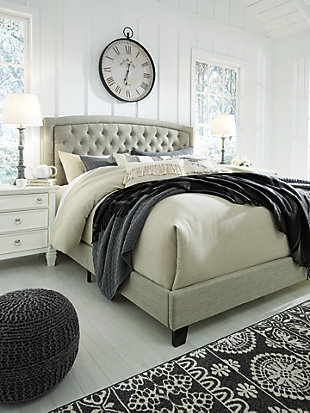 Set the scene for a heavenly bedroom retreat—at a down-to-earth price—with the Jerary queen upholstered bed. Light gray upholstery gracing the arched tufted headboard sports a textural weave that feels fresh and now. Footboard and rails are also dressed in cool gray tones. Includes upholstered headboard, footboard and rails | Engineered wood frame | Polyester upholstery | Button-tufted headboard | Wood feet with a dark brown finish | Foundation/box spring required, sold separately | Mattress available, sold separately | Assembly required | Estimated Assembly Time: 60 Minutes