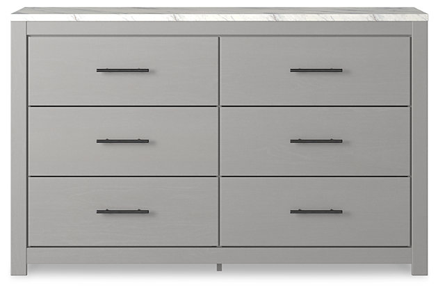 Cool, clean and casually modern. The Cottonburg dresser’s wispy dove gray finish and faux Calcutta marble top set the tone for your calming sanctuary. Large linear pulls add dimension and authenticity. Six smooth-gliding drawers neatly accommodate your wardrobe needs.Dresser only | Made of engineered wood (MDF/particleboard) | and decorative laminate | Wispy dove gray finish with replicated wood grain | Replicated Calcutta marble top | 6 smooth-gliding drawers with faux linen lining | Large scale dark colored handles | Safety is a top priority, clothing storage units are designed to meet the most current standard for stability, ASTM F 2057 (ASTM International) | Drawers extend out to accommodate maximum access to drawer interior while maintaining safety | Assembly required