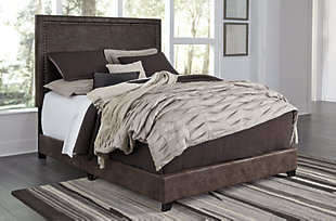 Covered in a fabulous faux leather fabric inspired by bomber jackets, the Dolante queen upholstered bed is high style at a comfortably affordable price. String of goldtone nailhead trim adds a punch of character to bed’s clean-lined profile. Mattress and foundation/box spring available, sold separately.Queen complete bed-in-a-box | Includes headboard, footboard and rails | Made of engineered wood with natural finish over replicated oak grain | Engineered wood frame with solid wood feet | Faux leather upholstery | Goldtone nailhead trim | Foundation/box spring required, sold separately | Mattress available, sold separately | Assembly required | All parts required for assembly of this bed are packed in the open space in the back of the headboard | Estimated Assembly Time: 45 Minutes