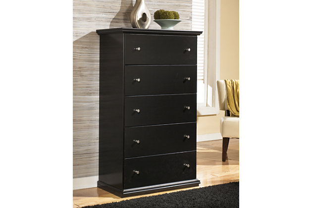 Clean, simple and beautiful. The Maribel chest of drawers provides ample space for clothing, accessories and spare bed linens. Pewter-tone knobs give a slightly industrial feel, making this piece at home among eclectic decor.Made of wood and engineered wood (MDF/particleboard) | Antiqued black finish | Rubbed dark metal hardware | 5 smooth-gliding drawers | Includes tipover restraint device | Small Space Solution | Safety is a top priority, clothing storage units are designed to meet the most current standard for stability, ASTM F 2057 (ASTM International) | Drawers extend out to accommodate maximum access to drawer interior while maintaining safety