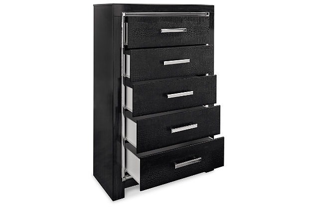 Rest easy. The luxurious look you’ve been dreaming of is yours for the taking, at a price sure to put you at ease. The Kaydell chest of drawers’ deep, dark finish, faceted chrome-tone accents and faux alligator panels exude Hollywood-chic style to the max. Sure to entice those with refined tastes, this chest is a contemporary masterpiece.Made of engineered wood and decorative laminate | Replicated walnut wood grain | Textured faux alligator panels | Chrome-tone faceted accents | 5 smooth-gliding drawers with faux linen lining and large chrome-tone pulls with faceted details | Safety is a top priority, clothing storage units are designed to meet the most current standard for stability, ASTM F 2057 (ASTM International) | Drawers extend out to accommodate maximum access to drawer interior while maintaining safety | Assembly required