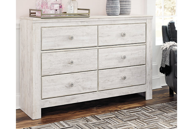 A one-of-a-kind girl deserves a bedroom retreat that celebrates her personal flair—and the Paxberry dresser is so befitting. Wowing with bohemian touches and a distressed whitewash finish, this dresser is rich with possibilities.Made of engineered wood (MDF/particleboard) | and decorative laminate | Whitewash replicated worn through paint with authentic touch | Hardware features a worn-through painted effect | 6 smooth-gliding drawers with faux laminate lining | Safety is a top priority, clothing storage units are designed to meet the most current standard for stability, ASTM F 2057 (ASTM International) | Drawers extend out to accommodate maximum access to drawer interior while maintaining safety