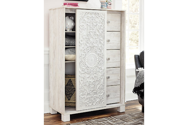 A one-of-a-kind girl deserves a bedroom retreat that celebrates her personal flair—and the Paxberry chest of drawers is so befitting. Wowing with an artful, carved-effect sliding door and richly distressed whitewash finish, this 5-drawer chest with additional shelved storage is packed with possibilities.Made of engineered wood and decorative laminate | Whitewash replicated worn through paint with authentic touch | 5 smooth-gliding drawers with faux laminate lining | Slider door revealing open storage with 3 adjustable shelves | Safety is a top priority, clothing storage units are designed to meet the most current standard for stability, ASTM F 2057 (ASTM International) | Drawers extend out to accommodate maximum access to drawer interior while maintaining safety