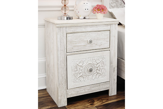 A one-of-a-kind girl deserves a bedroom retreat that celebrates her personal flair—and the Paxberry nightstand is so befitting. Wowing with artful, carved-effect detailing and richly distressed whitewash finish, this 2-drawer nightstand is a dream come true if you’re searching for something delightfully different. And with USB device charging, this nightstand is right up to speed with her high-tech lifestyle.Made of engineered wood (MDF/particleboard) and decorative laminate | Whitewash replicated worn through paint with authentic touch | 2 smooth-gliding drawers with faux laminate lining | 2 slim-profile USB charging ports | Power cord included; UL Listed | Minor assembly required