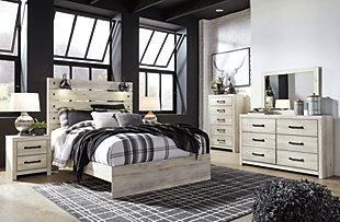 What a delightful take on rustic industrial style. Whether modern loft or modern farmhouse, the Cambeck queen panel bed makes itself at home. The wispy whitewash palette enhances without covering the grain for that weathered look you crave. Love to read in bed? You’re sure to find the retro-chic light sconces and USB plug-ins on the open-slat style headboard such a bright idea. Includes headboard, footboard and rails | Made of engineered wood (MDF/particleboard) and decorative laminate | Wispy white finish over replicated oak grain with authentic touch | 2 decorative sconce lights, LED with 3 AA batteries | 2 slim-profile USB charging ports | Power cord included; UL-listed | Foundation/box spring required, sold separately | Mattress available, sold separately | Assembly required | Estimated Assembly Time: 10 Minutes