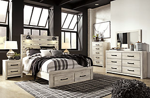 What a delightful take on rustic industrial style. Whether modern loft or modern farmhouse, the Cambeck queen panel storage bed makes itself at home. The wispy whitewash palette enhances without covering the grain for that weathered look you crave. Love to read in bed? You’re sure to find the retro-chic light sconces and USB plug-ins on the open-slat style headboard such a bright idea. Elongated metal drawer pulls on the footboard storage drawers elevate the aesthetic.Includes headboard, footboard and rails | Made of engineered wood and decorative laminate | Wispy white finish over replicated oak grain with authentic touch | Dark-tone industrial hardware | 2 decorative sconce lights, LED with 3 AA batteries | 2 smooth-gliding storage drawers | 2 slim-profile USB charging ports | Power cord included; UL-listed | Foundation/box spring required, sold separately | Mattress available, sold separately | Assembly required | Estimated Assembly Time: 10 Minutes