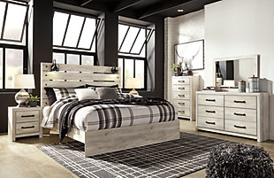 What a delightful take on rustic industrial style. Whether modern loft or modern farmhouse, the Cambeck king panel bed makes itself at home. The wispy whitewash palette enhances without covering the grain for that weathered look you crave. Love to read in bed? You’re sure to find the retro-chic light sconces and USB plug-ins on the open-slat style headboard such a bright idea.Includes headboard, footboard and rails | Made of engineered wood (MDF/particleboard) and decorative laminate | Wispy white finish over replicated oak grain with authentic touch | 2 decorative sconce lights, LED with 3 AA batteries | 2 slim-profile USB charging ports | Power cord included; UL-listed | Foundation/box spring required, sold separately | Mattress available, sold separately | Assembly required | Estimated Assembly Time: 10 Minutes