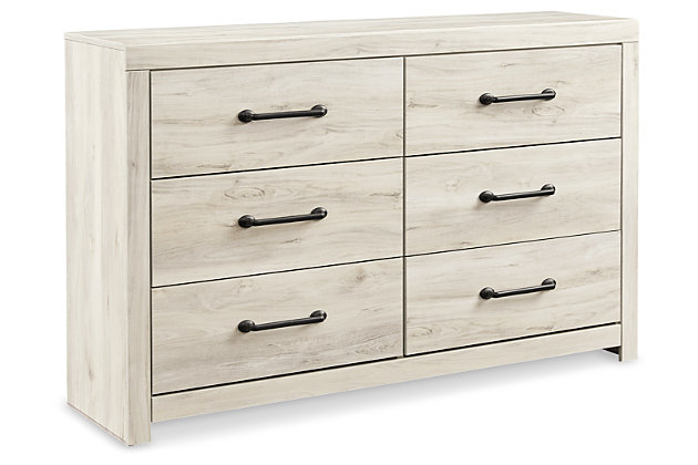 What a delightful take on rustic industrial style. Whether modern loft or modern farmhouse, the Cambeck dresser makes itself at home. The wispy whitewash palette enhances without covering the grain for that weathered look you crave. Elongated drawer pulls elevate the aesthetic.Made of engineered wood and decorative laminate | Wispy white finish over replicated oak grain with authentic touch | Large-scale hardware with dark finish | 6 smooth-gliding drawers with faux linen lining | Includes tipover restraint device | Safety is a top priority, clothing storage units are designed Made of engineered wood and decorative laminate | Wispy white finish over replicated oak grain with authentic touch | Dark-tone industrial hardware | 6 smooth-gliding drawers | Drawer interiors are lined with a faux linen laminate for a clean finished look | Safety is a top priority, clothing storage units are designed to meet the most current standard for stability, ASTM F 2057 (ASTM International) | Drawers extend out to accommodate maximum access to drawer interior while maintaining safety