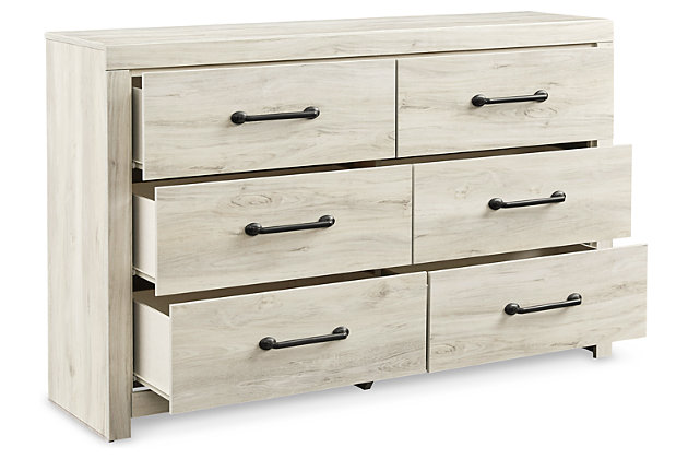 What a delightful take on rustic industrial style. Whether modern loft or modern farmhouse, the Cambeck dresser makes itself at home. The wispy whitewash palette enhances without covering the grain for that weathered look you crave. Elongated drawer pulls elevate the aesthetic.Made of engineered wood and decorative laminate | Wispy white finish over replicated oak grain with authentic touch | Large-scale hardware with dark finish | 6 smooth-gliding drawers with faux linen lining | Includes tipover restraint device | Safety is a top priority, clothing storage units are designed Made of engineered wood and decorative laminate | Wispy white finish over replicated oak grain with authentic touch | Dark-tone industrial hardware | 6 smooth-gliding drawers | Drawer interiors are lined with a faux linen laminate for a clean finished look | Safety is a top priority, clothing storage units are designed to meet the most current standard for stability, ASTM F 2057 (ASTM International) | Drawers extend out to accommodate maximum access to drawer interior while maintaining safety