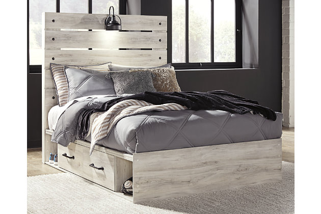 What a delightful take on rustic industrial style. Whether modern loft or modern farmhouse, the Cambeck full panel storage bed makes itself at home. The wispy whitewash palette enhances without covering the grain for that weathered look you crave. Love to read in bed? You’re sure to find the retro-chic light sconce and USB plug-ins on the open-slat style headboard such a bright idea. Elongated drawer pulls on the under bed storage drawers elevate the aesthetic.Includes headboard, footboard, side storage, rails and slats | Made of engineered wood (MDF/particleboard) and decorative laminate | Wispy white finish over replicated oak grain with authentic touch | Dark-tone industrial hardware | Decorative sconce light, LED with 3 AA batteries | 2 smooth-gliding storage drawers | 2 storage cubbies  | 2 slim-profile USB charging ports | Power cord included; UL-listed | Bed does not require a foundation/box spring | Mattress available, sold separately | Assembly required | Estimated Assembly Time: 45 Minutes
