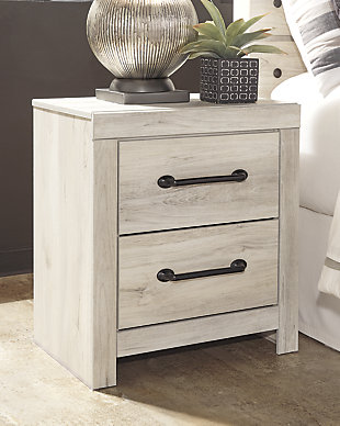 What a delightful take on rustic industrial style. Whether modern loft or modern farmhouse, the Cambeck nightstand makes itself at home. The wispy whitewash palette enhances without covering the grain for that weathered look you crave. Elongated drawer pulls elevate the aesthetic. Inclusion of USB plug-ins is such a bright idea.Made of engineered wood (MDF/particleboard) | and decorative laminate | Wispy white finish over replicated oak grain with authentic touch | Dark-tone industrial hardware | 2 smooth-gliding drawers | Drawers lined with faux linen laminate for finished aesthetic | 2 slim-profile USB charging stations | Power cord included; UL Listed