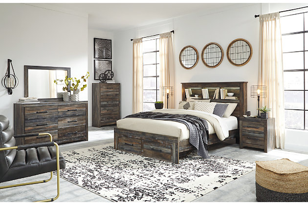 When merged in just the right way, rustic and industrial styles can make one happy marriage. Case in point: the Drystan queen bookcase bed with storage. A refined take on barn board beauty, its complex, replicated wood grain showcases hints of burnt orange and teal tones for a sense of weatherworn authenticity. Three open cubbies lined with a dimming LED light strip keep bedtime reads top of mind. Double drawers at the foot of the bed come in mighty handy.Includes bookcase headboard, footboard with storage and rails | Made of egineered wood (MDF/particleboard) and decorative laminate | Brown rustic finish with burnt orange and teal accents in a replicated wood grain with authentic touch | Headboard includes a dimming LED light | 2 smooth-gliding drawers in footboard | Small Space Solution | Foundation/box spring required, sold separately | Mattress available, sold separately | Assembly required | Estimated Assembly Time: 10 Minutes