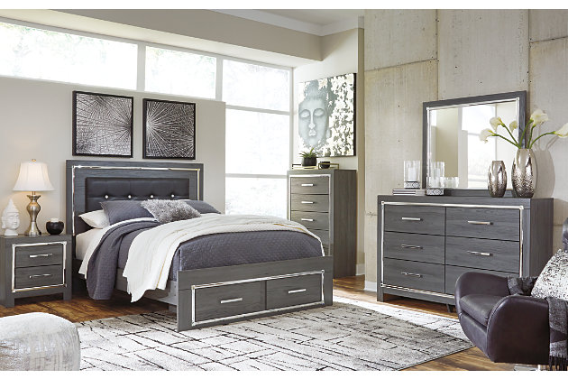 Reminiscent of Hollywood glamour of yesteryear, the Lodanna queen storage bed interprets luxury in a decidedly modern way. Sumptuous details include button-tufted upholstery, faceted faux crystals and chrome-tone accents beautifully lit by LED lights enhanced with remote-controlled settings for color and brightness.Includes headboard, footboard and side rails | Made of engineered wood (MDF/particleboard) and decorative laminate | Gray finish with replicated wood grain | Faux leather upholstery | Faux crystal and faceted chrome-tone metal accents | Accent LED lights with remote to control color and brightness | 2 smooth operating drawers | Power cord included; UL Listed | Small Space Solution | Foundation/box spring required, sold separately | Mattress available, sold separately | Assembly required | Estimated Assembly Time: 10 Minutes