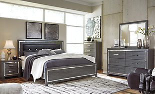 Reminiscent of Hollywood glamour of yesteryear, the Lodanna king panel bed interprets luxury in a decidedly modern way. Sumptuous details include button-tufted upholstery, faceted faux crystals and chrome-tone accents beautifully lit by LED enhanced with remote-controlled settings for color and brightness.Includes headboard, footboard and side rails | Made of egineered wood (MDF/particleboard) and decorative laminate | Gray finish with replicated wood grain | Faux leather upholstery | Faux crystal and faceted chrome-tone metal accents | Accent LED lights with remote to control color and brightness | Power cord included; UL Listed | Foundation/box spring required, sold separately | Mattress available, sold separately | Assembly required | Estimated Assembly Time: 10 Minutes