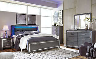 Reminiscent of Hollywood glamour of yesteryear, the Lodanna king panel bed interprets luxury in a decidedly modern way. Sumptuous details include button-tufted upholstery, faceted faux crystals and chrome-tone accents beautifully lit by LED enhanced with remote-controlled settings for color and brightness.Includes headboard, footboard and side rails | Made of egineered wood (MDF/particleboard) and decorative laminate | Gray finish with replicated wood grain | Faux leather upholstery | Faux crystal and faceted chrome-tone metal accents | Accent LED lights with remote to control color and brightness | Power cord included; UL Listed | Foundation/box spring required, sold separately | Mattress available, sold separately | Assembly required | Estimated Assembly Time: 10 Minutes