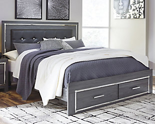 Reminiscent of Hollywood glamour of yesteryear, the Lodanna king panel bed with storage interprets luxury in a decidedly modern way. Sumptuous details include button-tufted upholstery, faceted faux crystals and chrome-tone accents beautifully lit by LED lights enhanced with remote-controlled settings for color and brightness.Includes headboard, storage footboard and side rails | Made of egineered wood (MDF/particleboard) and decorative laminate | Gray finish with replicated wood grain | Faux leather upholstery | Faux crystal and faceted chrome-tone metal accents | Accent LED lights with remote to control color and brightness | 2 smooth-operating drawers | Power cord included; UL Listed | Foundation/box spring required, sold separately | Mattress available, sold separately | Assembly required | Estimated Assembly Time: 10 Minutes