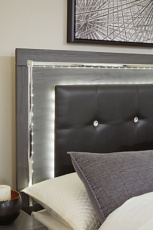 Reminiscent of Hollywood glamour of yesteryear, the Lodanna queen storage bed interprets luxury in a decidedly modern way. Sumptuous details include button-tufted upholstery, faceted faux crystals and chrome-tone accents beautifully lit by LED lights enhanced with remote-controlled settings for color and brightness.Includes headboard, footboard and side rails | Made of engineered wood and decorative laminate | Gray finish with replicated wood grain | Faux leather upholstery | Faux crystal and faceted chrome-tone metal accents | Accent LED lights with remote to control color and brightness | 2 smooth operating drawers | Power cord included; UL Listed | Small Space Solution | Foundation/box spring required, sold separately | Mattress available, sold separately | Assembly required | Estimated Assembly Time: 10 Minutes