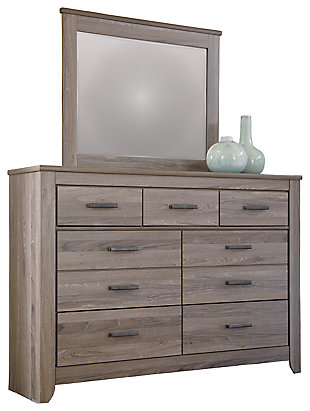 Urban sophistication with a decidedly relaxed air. If effortless elegance is the impression you’re going for, the Zelen dresser and mirror set is custom made to fit your space. It’s got the crisp, clean lines of a contemporary piece, but with softly weathered elements, including antiqued industrial pulls and an earthy finish that lets the beauty of replicated oak grain flow through. Seven smooth-gliding drawers of varied size make it a bedroom essential.Made of engineered wood and decorative laminate | Warm gray vintage finish with white wax effect over replicated oak grain | Pewter-tone hardware | 7 smooth-operating drawers | Mirror attaches to back of dresser | Includes tipover restraint device | Assembly required | Estimated Assembly Time: 5 Minutes