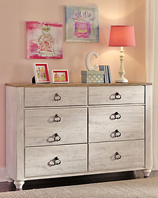 The Willowton dresser is the ultimate statement piece for a coastal cottage or shabby chic inspired retreat. Whitewashed finish on the drawers and sides is wonderfully easy on the eyes. Paired with the unique plank-effect top, it’s a driftwoody look that has our minds drifting away to beachy-keen escapes.Dresser only | Made of engineered wood (MDF/particleboard) and decorative laminate | Whitewash replicated worn through paint with authentic touch | Replicated wood grained block pattern with authentic touch | Antiqued brass-tone ring-pull hardware | 6 smooth-gliding drawers | Safety is a top priority, clothing storage units are designed to meet the most current standard for stability, ASTM F 2057 (ASTM International) | Drawers extend out to accommodate maximum access to drawer interior while maintaining safety | Assembly required