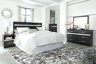 Starry, starry nights. Inspired by Hollywood glam, the richly styled Starberry king/California king panel headboard steals the show in a simply stunning way. The headboard’s replicated walnut grain is enriched with a high-gloss black finish, made even more dramatic with a strip of sleek silver glitter banding that accentuates a clean-lined, contemporary aesthetic. This headboard is also mighty accommodating, with four adjustable heights to suit your mood and your space.Headboard only | Made of engineered wood (MDF/particleboard) and decorative laminate | High gloss black finish with replicated straight silver walnut grain framed in black finish | Silvertone glitter accent | 4 adjustable heights | ¼" bolts (not included) are needed to attach headboard to existing bed frame | Bolt (not included) length depends on the thickness of your bed frame | Assembly required
