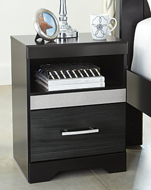 Starry, starry nights. Inspired by Hollywood glam, the richly styled Starberry nightstand steals the show in a simply stunning way. The nightstand’s replicated walnut grain is enriched with a high-gloss black finish, made even more dramatic with a strip of sleek silver glitter banding that accentuates a clean-lined, contemporary aesthetic. Discreetly positioned USB charging makes it all the more accommodating.Made of engineered wood (MDF/particleboard) and decorative laminate | High gloss black finish with replicated straight silver walnut grain framed in black finish | Silvertone glitter accent | Smooth-gliding drawer | Chrome-tone hardware with faux crystals | 2 slim-profile USB charging stations | Power cord included; UL Listed | Assembly required