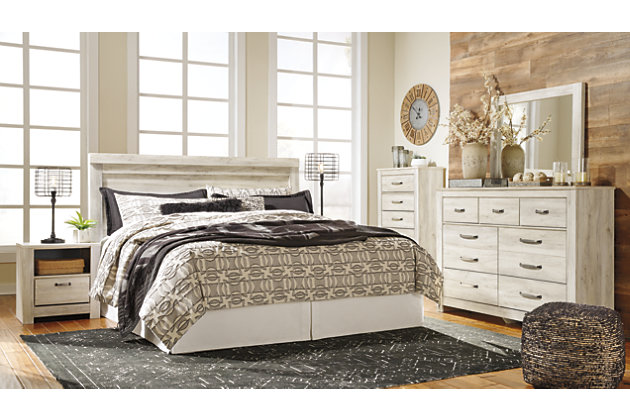 Your bedroom isn’t just a room. It’s a canvas. Express your farmhouse style with the 5-piece Bellaby bedroom set. Wispy white finish over replicated oak wood grain is a delightful change from the ordinary. Clean-lined, classic styling provides a countrified-chic bedroom retreat that’s a breath of fresh air. Queen panel bed is accompanied by a pair of nightstands, each with USB stations for your convenience. Mattress and foundation/box spring available, sold separately.Includes panel bed (headboard, footboard and rails) and two 1-drawer  nightstands | Made of engineered wood (MDF/particleboard) and decorative laminate | Wispy white finish over replicated oak grain with authentic touch | Brushed nickel-tone hardware with black edging | Nightstand with smooth-gliding drawers lined with faux linen laminate | Nightstand with storage cubby; 2 slim-profile USB ports | Power cord included; UL Listed | Foundation/box spring required, sold separately; mattress available, sold separately | Safety is a top priority, clothing storage units are designed to meet the most current standard for stability, ASTM F 2057 (ASTM International) | Drawers extend out to accommodate maximum access to drawer interior while maintaining safety | Assembly required | Estimated Assembly Time: 10 Minutes