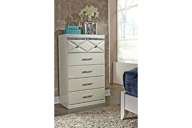 Love sleek and bold contemporary style? Live the dream with the Dreamur chest. Eye-catching details include 3D pressed top drawers with beveled mirror banding. Faux crystal accented handles and knobs incorporate an added touch of sheen and shine.Made of engineered wood (MDF/particleboard) | Mirrored banding | Faux crystal hardware | 5 smooth-operating drawers | Small Space Solution | Includes tipover restraint device | Safety is a top priority, clothing storage units are designed to meet the most current standard for stability, ASTM F 2057 (ASTM International) | Drawers extend out to accommodate maximum access to drawer interior while maintaining safety
