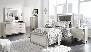Taking its cues from Hollywood Regency interiors, the Lonnis dresser and mirror set is puttin’ on the ritz in a big way. An ultra-clean profile is elevated with a spectacular metallic silvertone finish made all the more interesting with a hint of embossed texturing on the sleek, flush-mount drawers. Beveled mirror trim that frames both the dresser and mirror creates a rich, reflective effect, while ultra-modern nickel-tone pulls with faux crystal insets serve as a fabulous finishing touch.Made of wood and engineered wood | Silvertone metallic finish | 6 smooth-gliding drawers with dovetail construction | Embossed, textural drawer fronts  | Bright nickel-tone pulls with faux crystal insets | LED backlights for ambiance | Mirror attaches to back of dresser | Assembly required | Includes tipover restraint device | Estimated Assembly Time: 50 Minutes