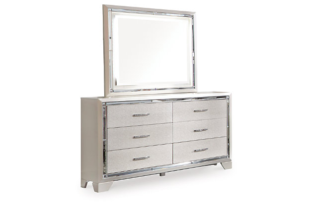 Taking its cues from Hollywood Regency interiors, the Lonnis dresser and mirror set is puttin’ on the ritz in a big way. An ultra-clean profile is elevated with a spectacular metallic silvertone finish made all the more interesting with a hint of embossed texturing on the sleek, flush-mount drawers. Beveled mirror trim that frames both the dresser and mirror creates a rich, reflective effect, while ultra-modern nickel-tone pulls with faux crystal insets serve as a fabulous finishing touch.Made of wood and engineered wood | Silvertone metallic finish | 6 smooth-gliding drawers with dovetail construction | Embossed, textural drawer fronts  | Bright nickel-tone pulls with faux crystal insets | LED backlights for ambiance | Mirror attaches to back of dresser | Assembly required | Includes tipover restraint device | Estimated Assembly Time: 50 Minutes