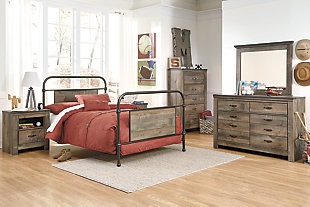 Whether she loves horses or he's a cowboy at heart, the Trinell chest of drawers matches their authenticity. Rustic finish, plank-style details and nailhead trim pay homage to reclaimed barn wood, making for a chic look loaded with charm. Five roomy drawers keep clothing or toys nicely reined in.Made of engineered wood (MDF/particleboard) and decorative laminate | Warm rustic plank finish over replicated oak grain and authentic touch | Antiqued bronze-tone hardware | 5 smooth-operating drawers | Nailhead accents | Safety is a top priority, clothing storage units are designed to meet the most current standard for stability, ASTM F 2057 (ASTM International) | Drawers extend out to accommodate maximum access to drawer interior while maintaining safety | Assembly required