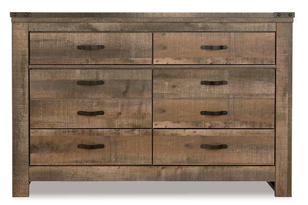 Whether she loves horses or he's a cowboy at heart, the Trinell dresser matches their authenticity. Rustic finish, plank-style details and nailhead trim pay homage to reclaimed barn wood, making for a chic look loaded with charm. Six roomy drawers keep clothing or toys nicely reined in.Dresser only | Made of engineered wood and decorative laminate | Warm rustic plank finish over replicated oak grain and authentic touch | Antiqued bronze-tone hardware | 6 smooth-operating drawers | Nailhead accents | Safety is a top priority, clothing storage units are designed to meet the most current standard for stability, ASTM F 2057 (ASTM International) | Drawers extend out to accommodate maximum access to drawer interior while maintaining safety | Assembly required
